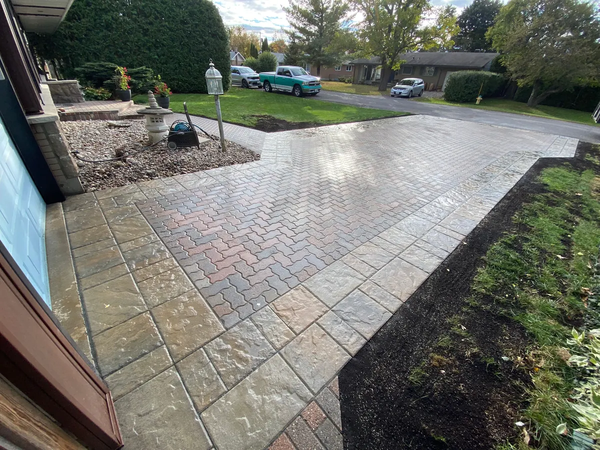 Wide interlock driveway finished with a cut stone border